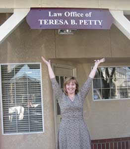 Photo of Teresa B. Petty-Jones standing in front of her office sign
